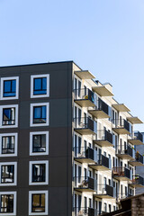 Contemporary building facade with some balconies. Close up of a modern apartment building.