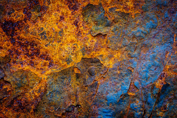 Rusty metal surface with shabby background paint. Blue cracked paint texture on an iron sheet....