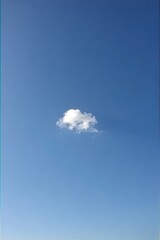 Obraz premium Lone Cloud in Blue Sky