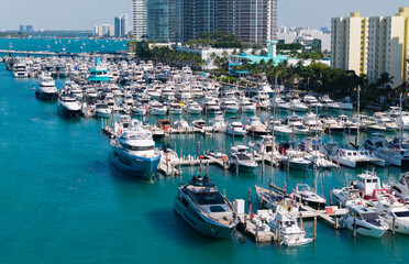 Aerial view of luxury yachts in Miami marina. Scenic panorama of boats and skyscrapers in Miami marina. Cruise yacht sailing along the Miami coastline. Miami Beach harbor. Sailboats and yachts at pier