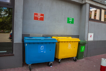 Garbage sorting. Plastic garbage containers in blue, yellow, green colors. Recycle waste. Recycling...