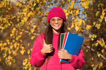 knowledge and education. september 1. autumn nature in september. school girl study in autumn. education in modern school. autumn style of teen girl going to school. thumb up
