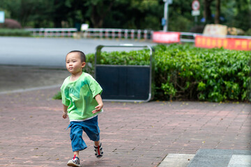 little boy walking in the park