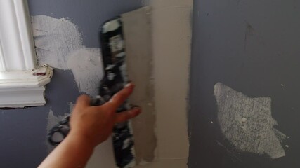 Female Construction Worker Uses A Putty Knife To Apply Finishing Compound Evenly On Wall Surface, Demonstrating Accurate And Careful Home Renovation Technique.