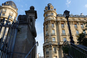 The facade of traditional French house with typical balconies and windows. Paris, France.