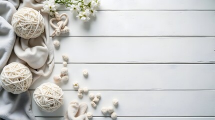 Natural textures of yarn and flowers arranged on a white wooden surface for creative crafting and decorating