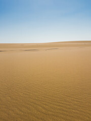 Ash-covered hills in Egypt's Black Desert under a clear sky, scenic and remote landscape. Volcanic	