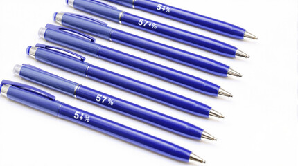 Blue ballpoint pens arranged in a row on white background, copy space