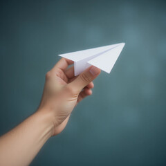 Hand holding paper airplane against textured background, copy space