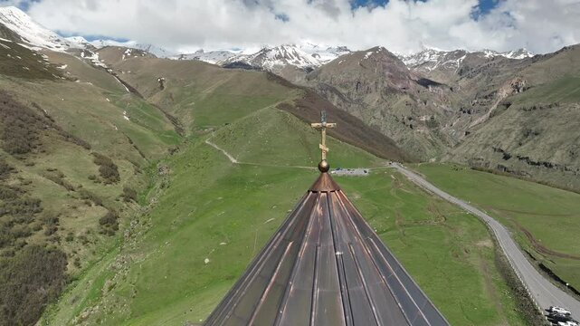 Aerial view of ancient Gergeti Trinity church Tsminda Sameba, near mount Kazbek, a landmark of Georgia, Caucasus mountains. May 26 2025