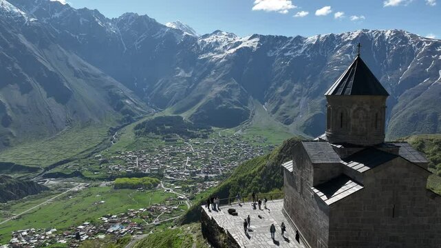 Aerial view of ancient Gergeti Trinity church Tsminda Sameba, near mount Kazbek, a landmark of Georgia, Caucasus mountains. May 26 2025