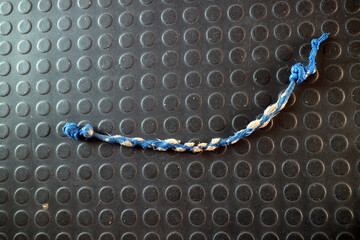 Blue and White Braided Rope on Textured Mat