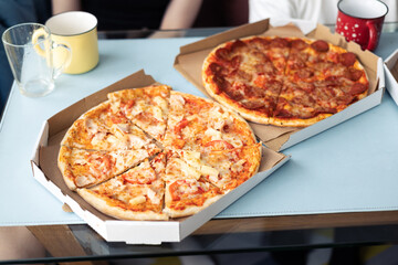 Food delivery. Ordering dinner online from the restaurant. Family meal at home. Pepperoni and...