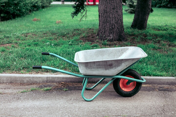 Wheelbarrow in the garden. Gardening equipment. Gardening concept.