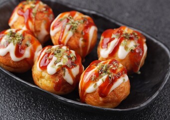 Takoyaki is a typical Japanese snack in the form of small balls made from wheat flour dough and...