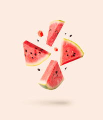 Watermelon pieces isolated with ceeds flying isolated on white. Falling slices set.