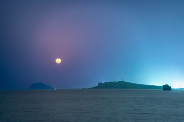 Calm night view of Xiaojilong Island off Shimen coast, bathed in soft moonlight under a peaceful...