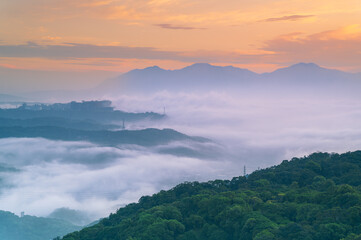 Rolling morning fog and clouds envelop the mountains of Shulin District New Taipei City Taiwan,...