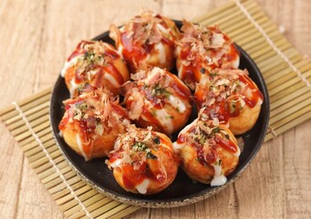 Takoyaki is a typical Japanese snack in the form of small balls made from wheat flour dough and filled with pieces of octopus.