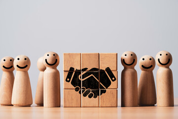 Wooden figures with smiling faces, symbolizing collaboration and teamwork, centered around a...