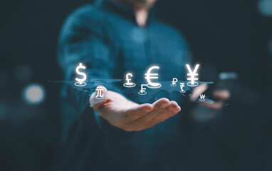 Global currency exchange and forex concept, Business man hand holding world with virtual line effect and dollar yuan yen euro and pound sterling sign with copy space.