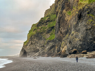 Female traveler on Reynisfjara Beach, Iceland