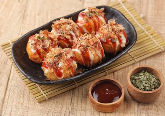 Takoyaki is a typical Japanese snack in the form of small balls made from wheat flour dough and filled with pieces of octopus.