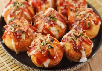 Takoyaki is a typical Japanese snack in the form of small balls made from wheat flour dough and filled with pieces of octopus.