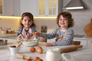 Cooking recipe. Cute children making dough for cookies at table in kitchen