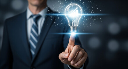 Businessman activating a glowing lightbulb representing innovative ideas and solutions