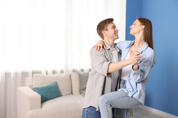 Obraz premium Happy couple dancing at home. Space for text
