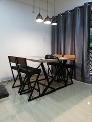 Apartment renovation interior showing wall repainting, lighting setup, furniture arrangement, and bathroom upgrade in clean modern living space