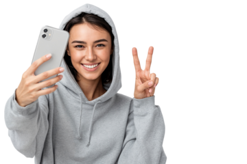 Happy young woman taking selfie with smartphone and showing peace sign