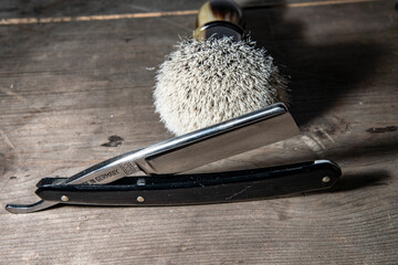 barber stilllife with a brush and a razor on wood dark colurs