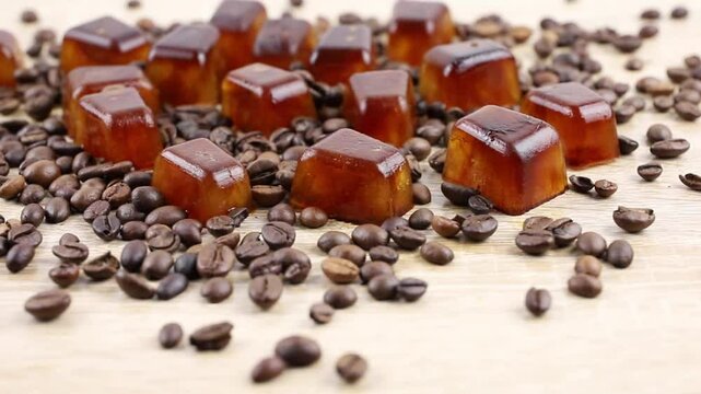 Side view of coffee ice cuber scattered on table, decorated with coffee beans. Studio shot. Concept of coffee ice cubes for making iced coffee.