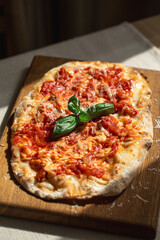 Pinsa margherita with tomato, cheese and basil on wooden board