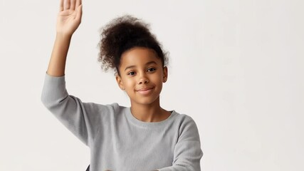 Portrait of a smiling african american elementary school student raising her hand to answer a question on a white background - Powered by Adobe