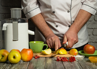 A chef slices apples on a wooden cutting board while using a juicer in a warm kitchen. Green...