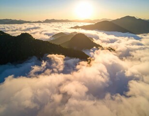 Obraz premium Aerial view of mountains emerging from a sea of clouds at dawn