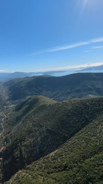 Powered paragliding paramotor flying over Albanian coast mountains and beaches aerial panorama landscape view,Albania,Balcan