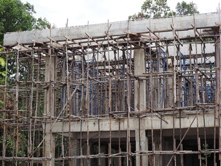 Wood scaffolding or wooden scaffolding. Scaffolding, usually made of metal or wood, is essential to construction sites. It provides easy access to areas and keeps workers safe.Bricklayer,Scaffold pole