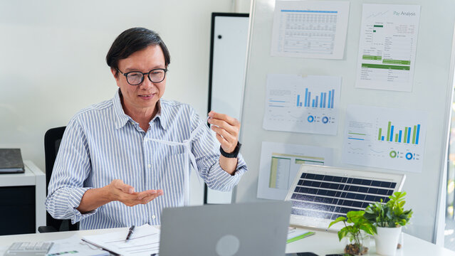 Asian adult business professional presenting ESG renewable energy solutions for sustainable corporate environmental governance and green innovation strategy