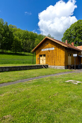 Zubrnice Train Station Building in Czechia with Lush Green Grass and Blue Sky