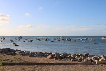 Fortaleza, Cear&aacute;, Brazil &ndash; December 11, 2024: Fishing boats anchored at Mucuripe beach under blue sky