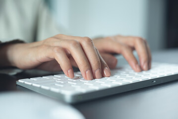 Closeup, business woman hand typing on desktop computer keyboard, online working, searching the...