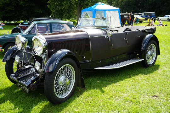 Fototapeta Newby Hall and Gardens, North Yorkshire, England – July 15 2023: Vintage classic convertible car showcased at an outdoor auto event.