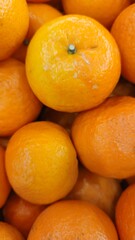 Close up pile of tasty fresh oranges sold at the market as a background.