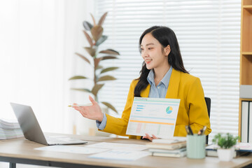 Business Woman's Presentation: An elegant businesswoman confidently presents charts and graphs...