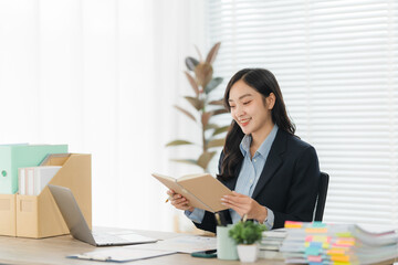 Productive Reflection: A professional woman, radiates a sense of focus and dedication, engrossed in...