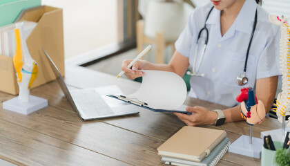 Health Professional's Office: A dedicated medical expert meticulously examines patient records within a modern, well-lit practice, providing exceptional medical care.